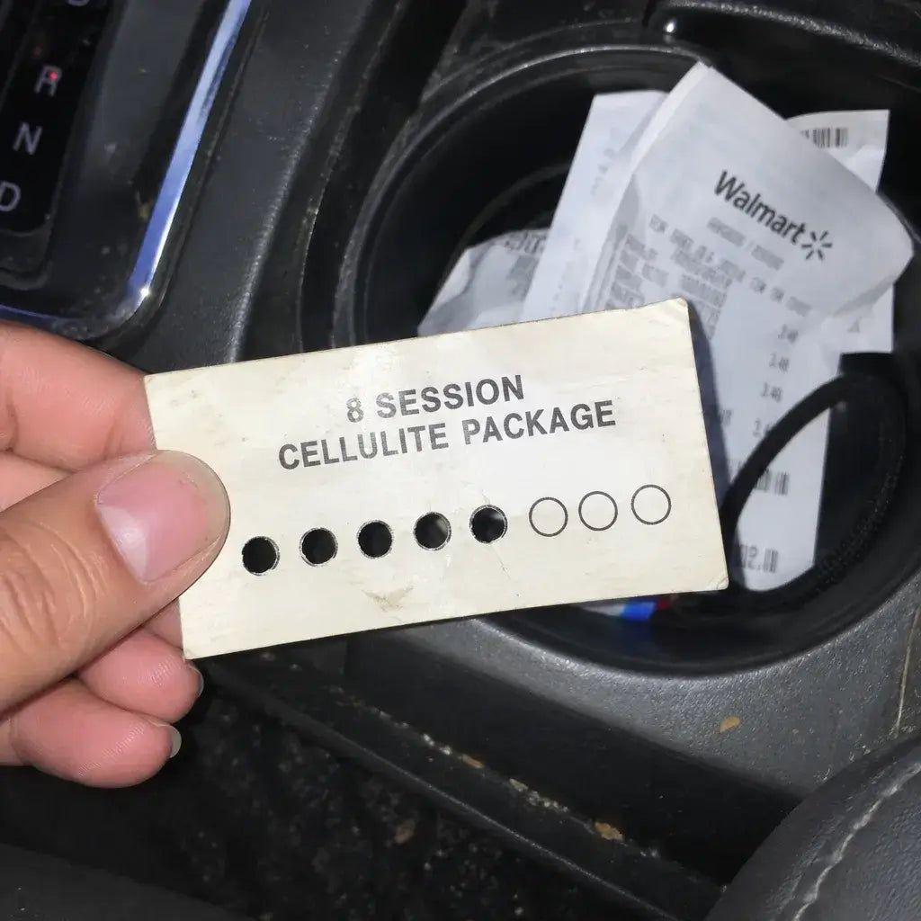 An 8-session cellulite punch card with three empty circles on a bathroom counter